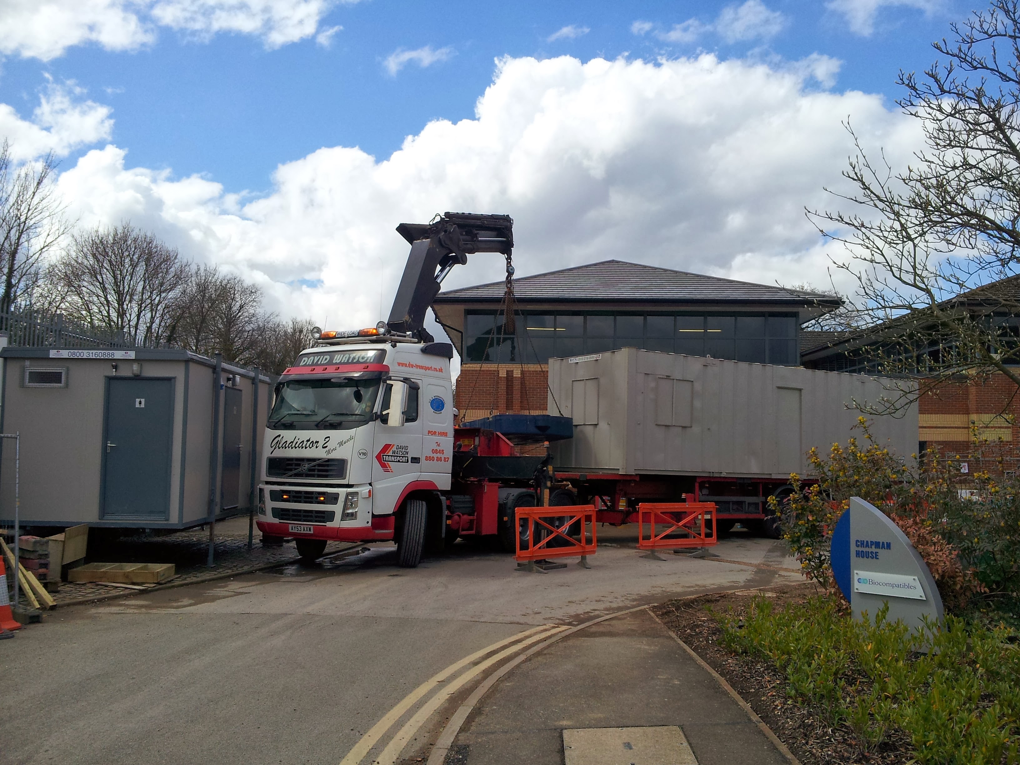 Lorry delivering temporary offices for construction of new facility