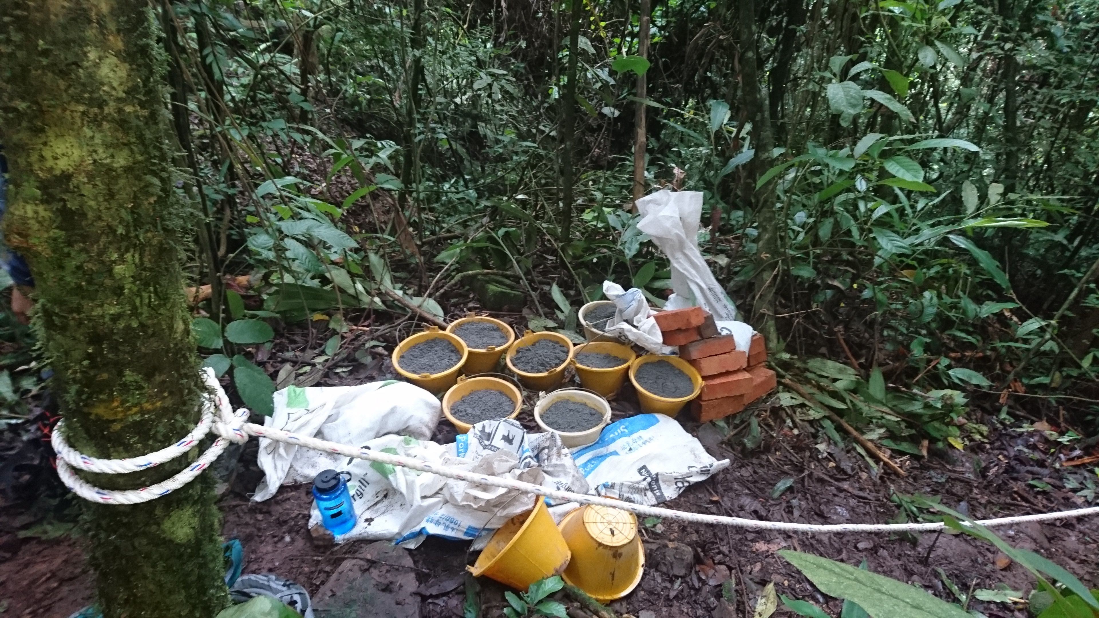 The 'sikit sikit' (little by little): 1.5-litre buckets of cement, safely sized for students, carried up a 700m jungle trail in Papar, Sabah, to build a vital reservoir at a clean spring.