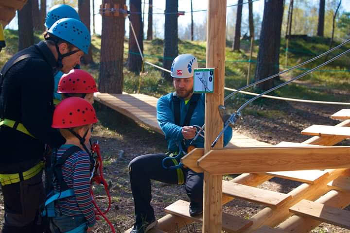 Nick provides safety instruction to a family visiting TrollPark Hove High Ropes Adventure
